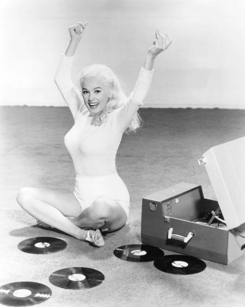 Mamie Van Doren with a record player and a collection of records, 1955.