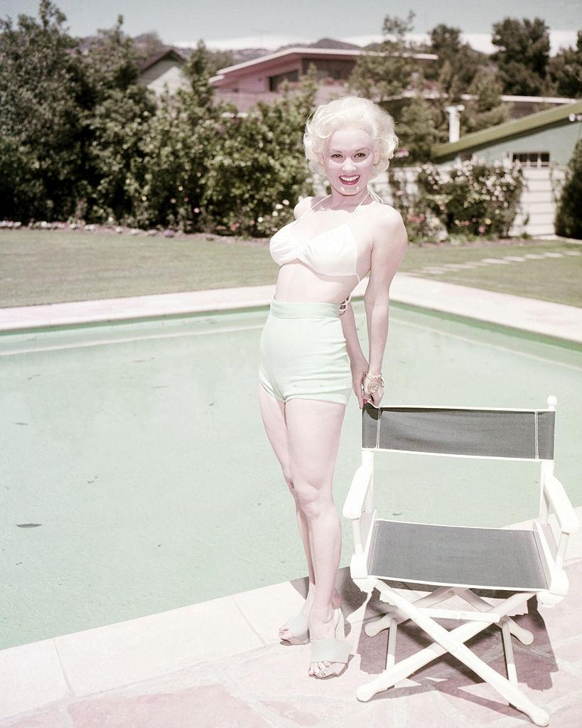 Mamie Van Doren by a swimming pool, 1955.