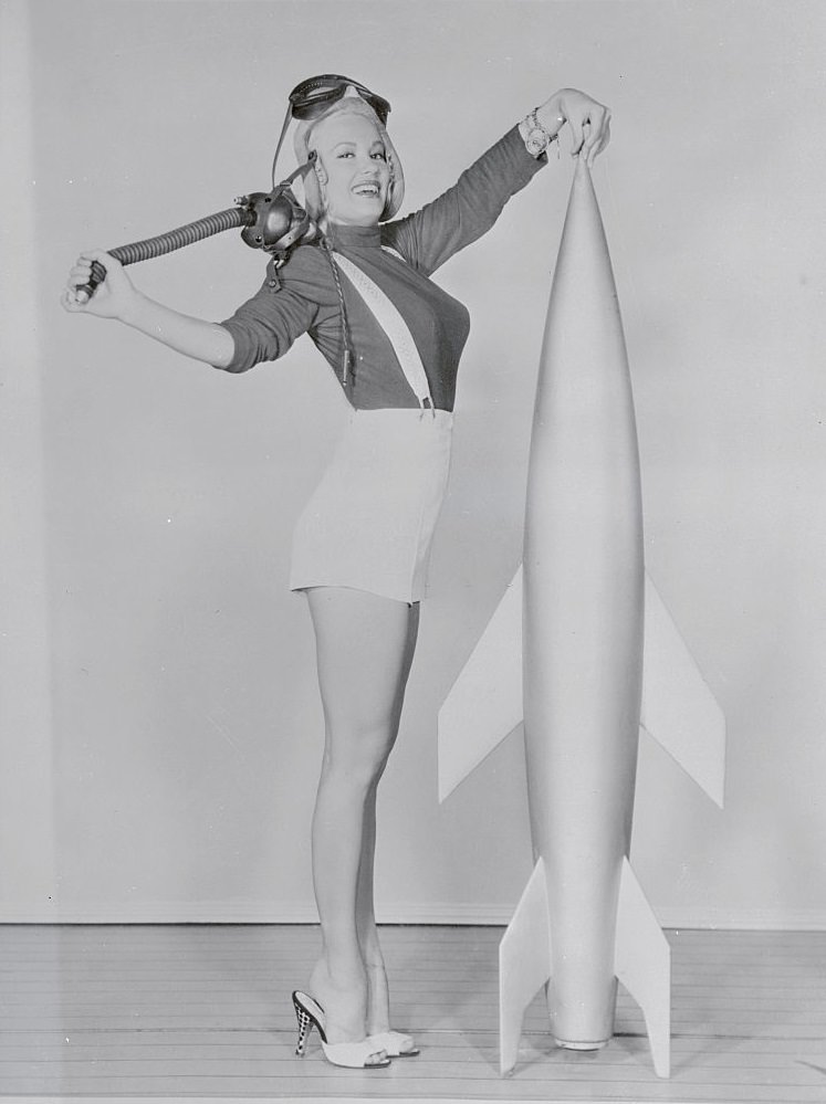 Mamie Van Doren Standing by Mock Rocket, 1955.