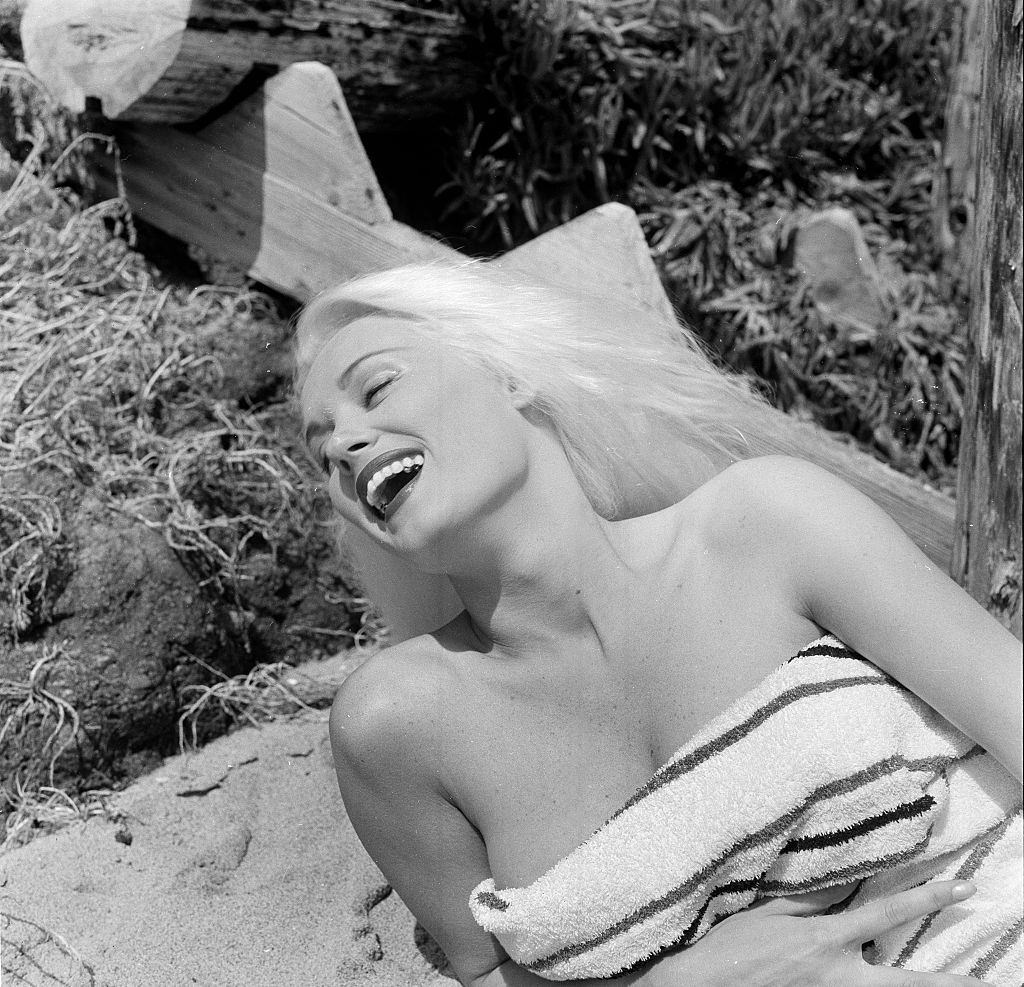 Mamie Van Doren poses at the beach in Los Angeles, 1956.