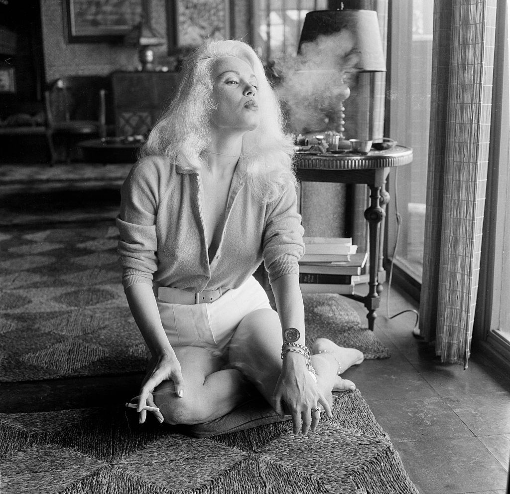 Mamie Van Doren smoking a cigarette, 1956.