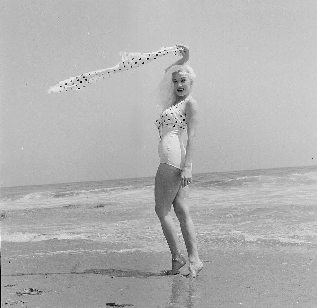 Mamie Van Doren enjoying on the beach, 1956.