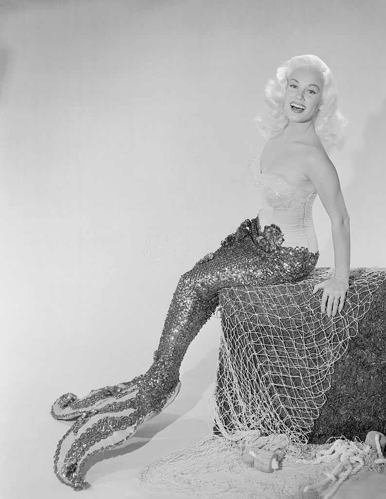 Mamie Van Doren Sitting on Rock in Mermaid Suit, 1957.