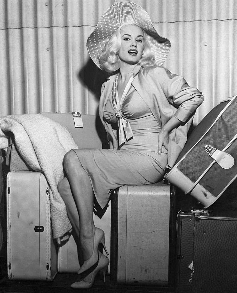 Mamie Van Doren Sitting on Her Luggage, 1958.