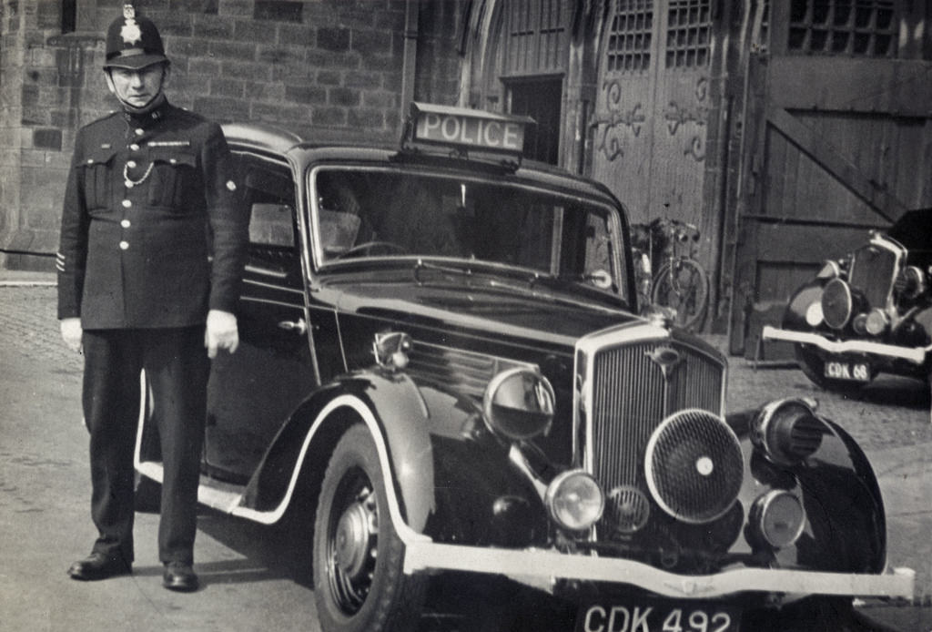 An officer of Rochdale Borough Police poses with his motor vehicle outside police headquarters in the early 1940s