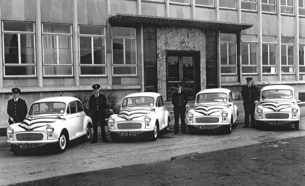 Stockport Borough Police officers stand proudly beside their Morris Minor 1000s outside the force’s headquarters on the town's Lee Street in the late 1950s