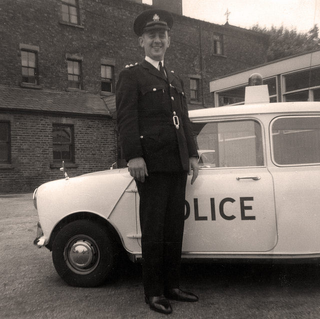 Manchester City Police's Inspector Albert Leach stands beside a Mini Cooper S patrol car sometime during the mid 1960s.
