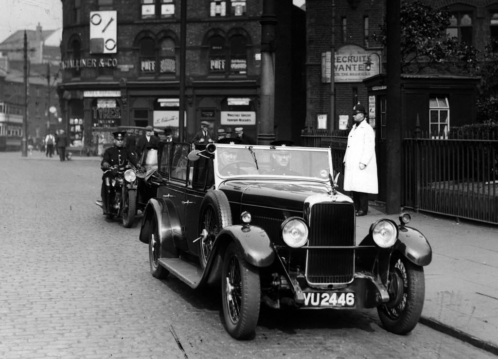 A Manchester City Police Alvis patrol car along with a motorcycle and sidecar in 1930s