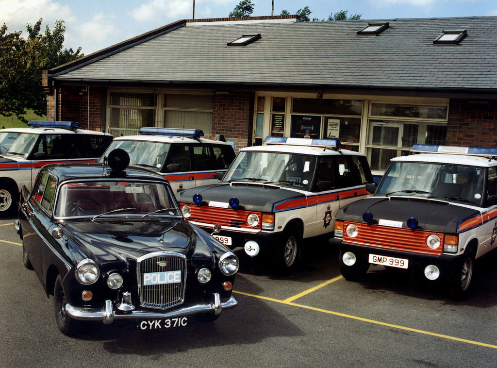 The classic 1965 Wolseley 15.60 alongside some of GMPs fleet of motorway patrol Range Rovers at their base at Birch on the M62, 1965.
