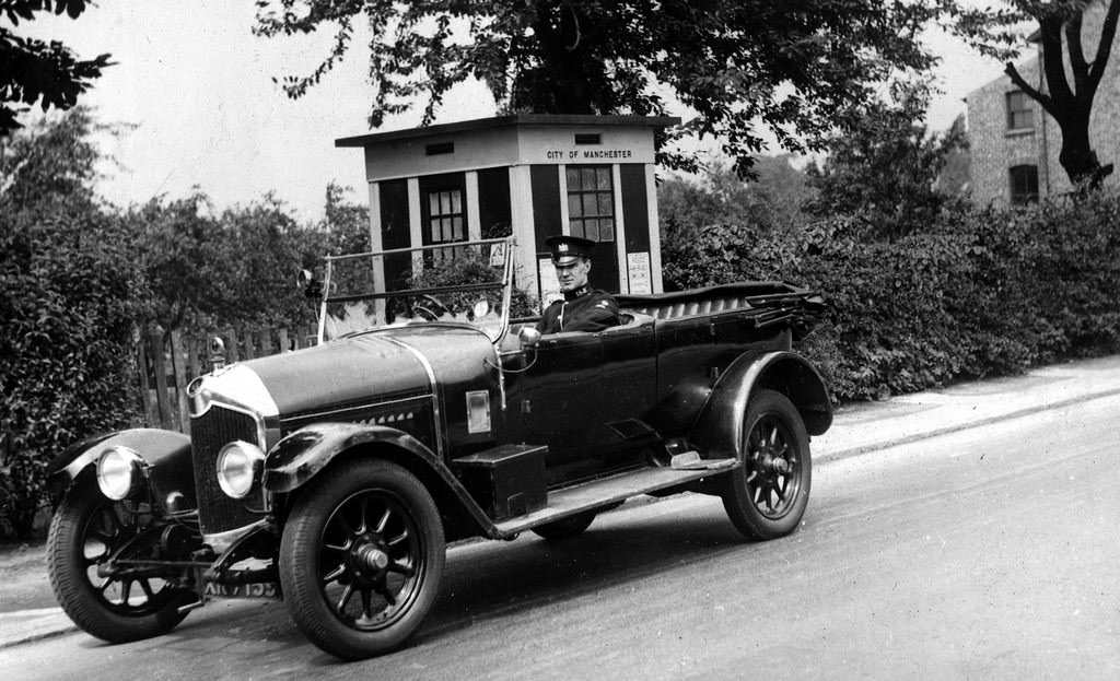 A Manchester City Police vehicle sits outside one of the force's police boxes in the 1930s