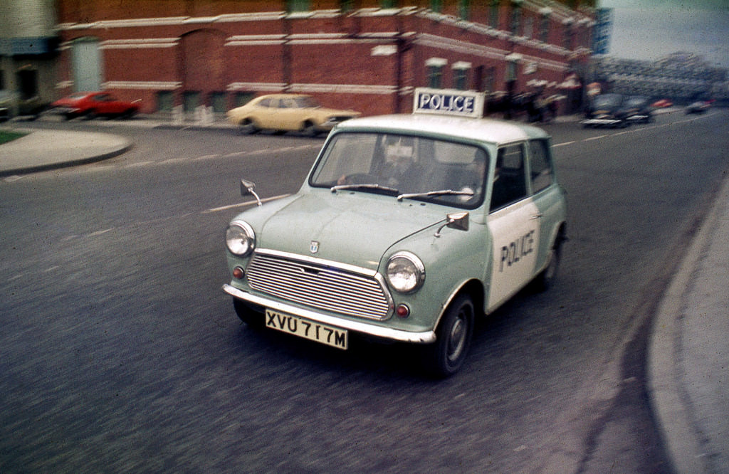 Two police officers travel in one of the most famous British cars ever to take to the road, 1973