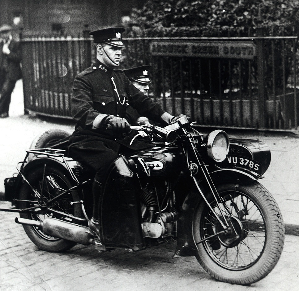 Manchester City Police officers on board a BSA motorcycle and sidecar in Ardwick Green on the edge of Manchester city centre during the 1930s