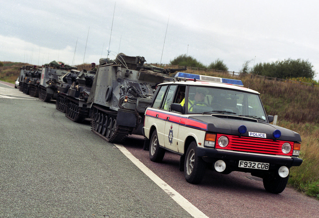 A Greater Manchester Police Range Rover stands ready to escort an army convoy through the regions motorway network in the early 1990s
