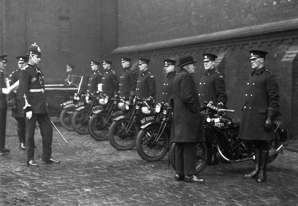 The chief constable of Oldham Borough Police watches an inspection of the force's motorcyclists, 1935.