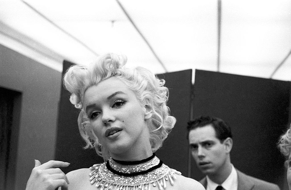 Marilyn Monroe gets fitted for her costume in a dressing room, March 1955.