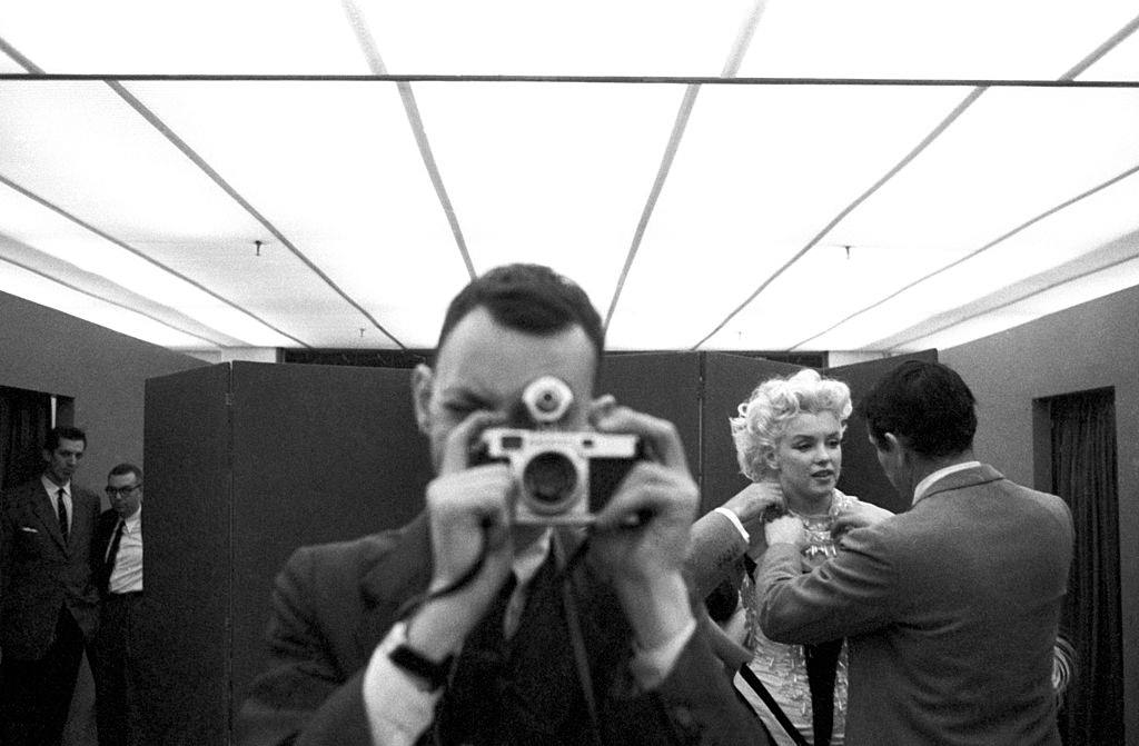 Photographer Ed Feingersh in the dressing room where Monroe is getting dressed.