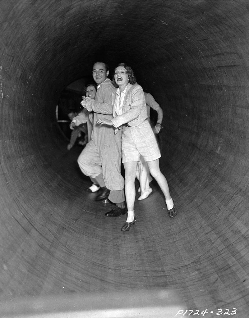 Marlene Dietrich attempt to stay upright in a spinning tunnel, 1930.
