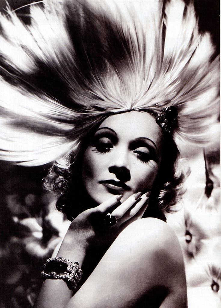 Marlene Dietrich wearing an exotic headdress designed by Travis Banton for the film 'Angel', 1930.