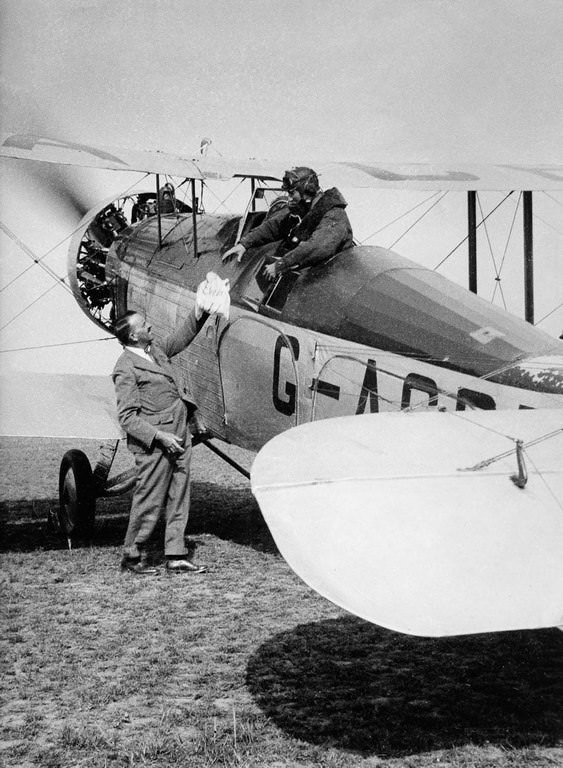 Colonel P.T. Etherton passes the expedition crew a bag of “Everest mail” before they set out for the mountain.