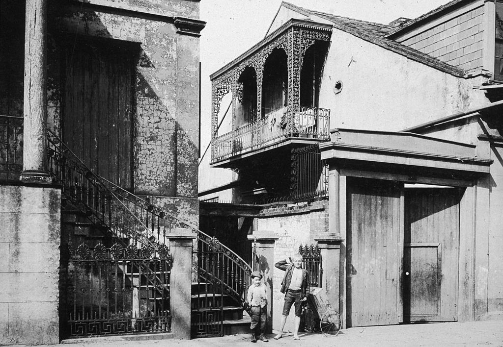 Two young boys stood by the side entrance to the Old Beauregard Home in the French Quarter of New Orleans, 1899.