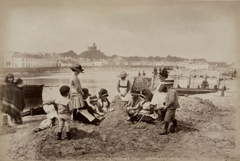 Children building another moat in the sand