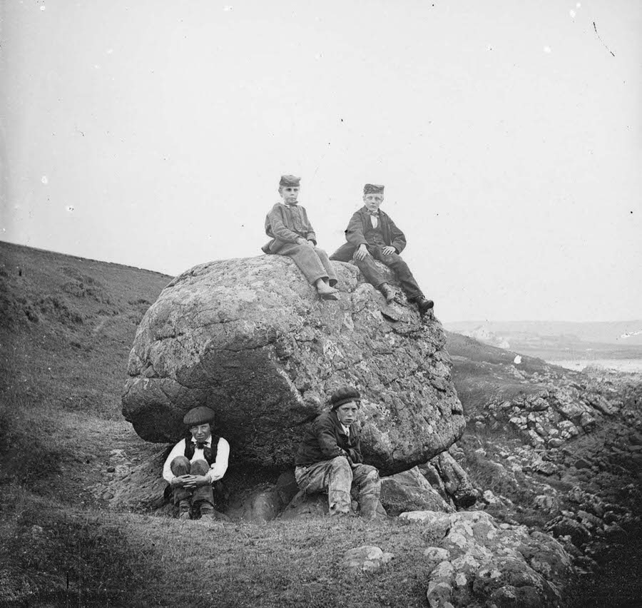Four boys at the “Rocking Stone” at Islandmagee, County Antrim. 1870.