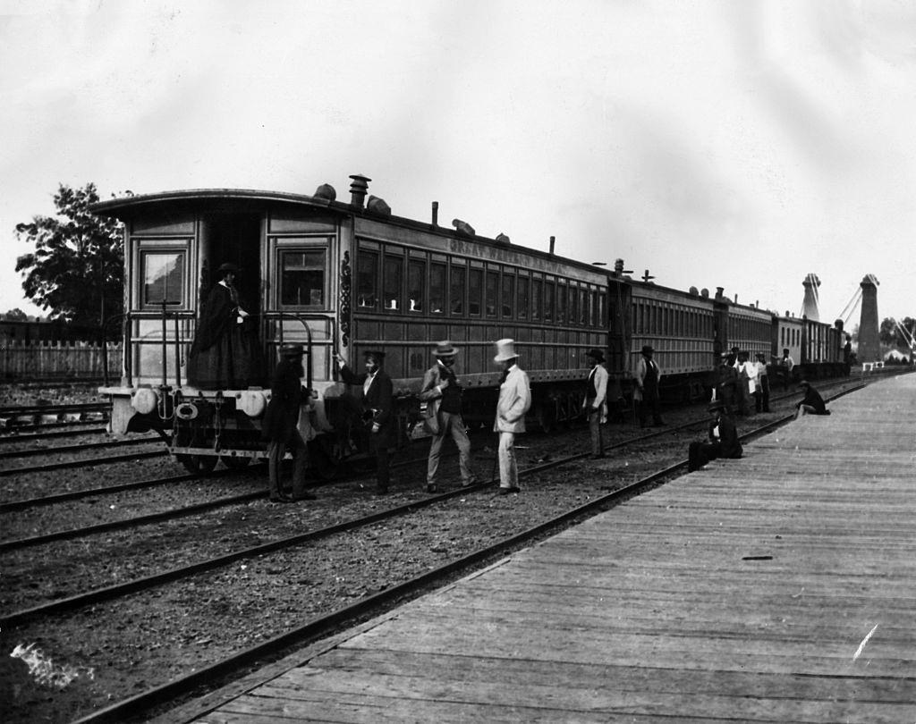 Passengers board carriages of the Canadian Great Western Railway at Clifton Depot, Niagara, 1859.