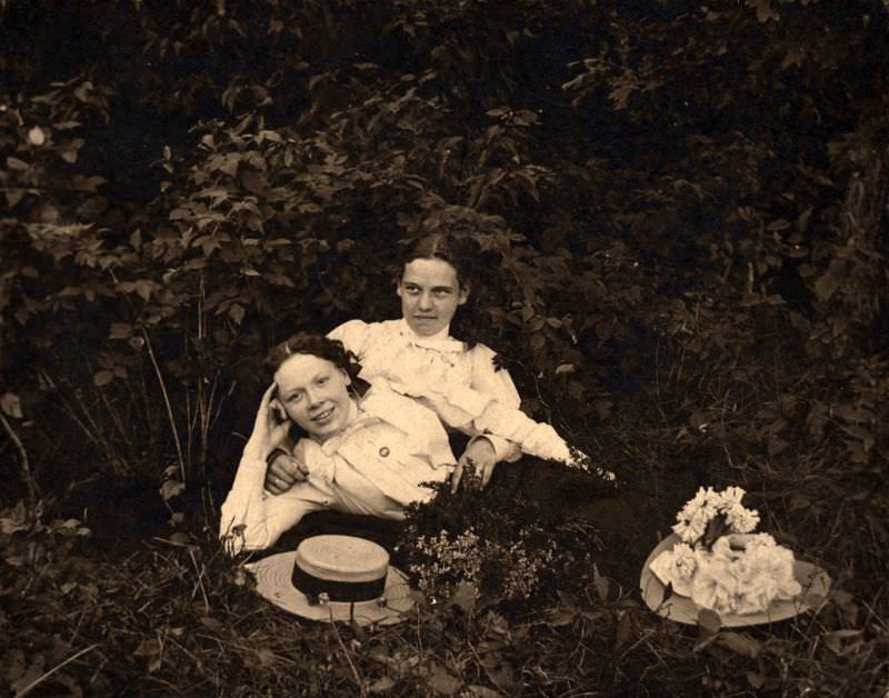 Two women laying among foliage from Ontario, 1890s.