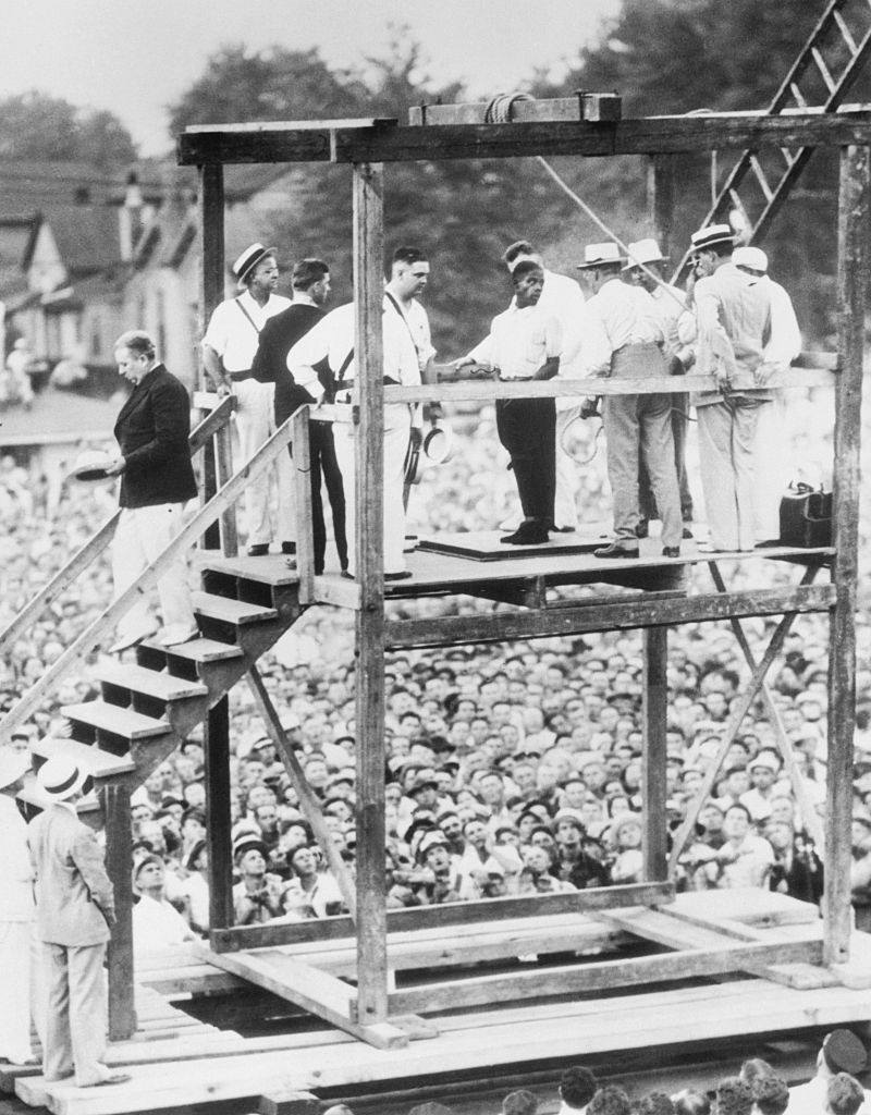 Bethea talking to an officer, just before he was hanged in the presence of a crowd estimated at 20,000 persons.