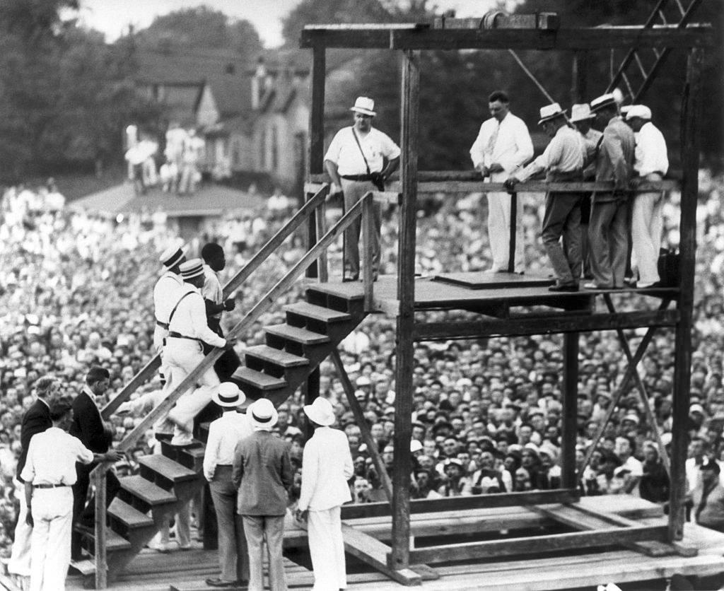 Police officers taking Bethea to the gallows.