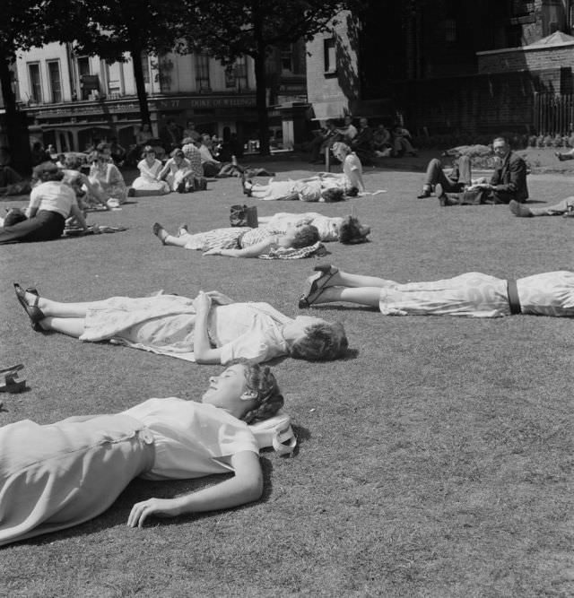 Londoners relaxing during a summer heat wave at St Anne’s Churchyard Gardens, 1952.