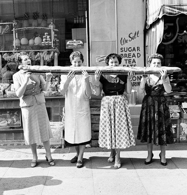 Four women sharing a 9-foot-long baguette, 1955.
