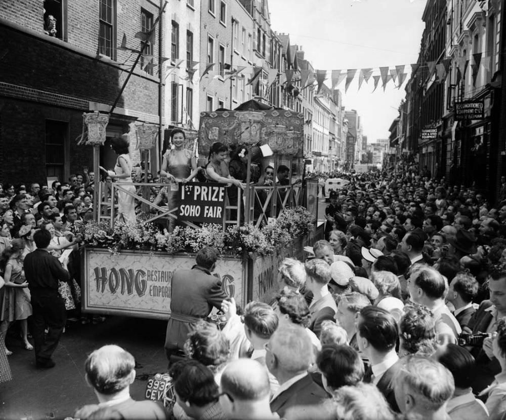The first prizewinning tableau on parade through the streets of Soho, London, at the opening of the Soho Fair in 1955.