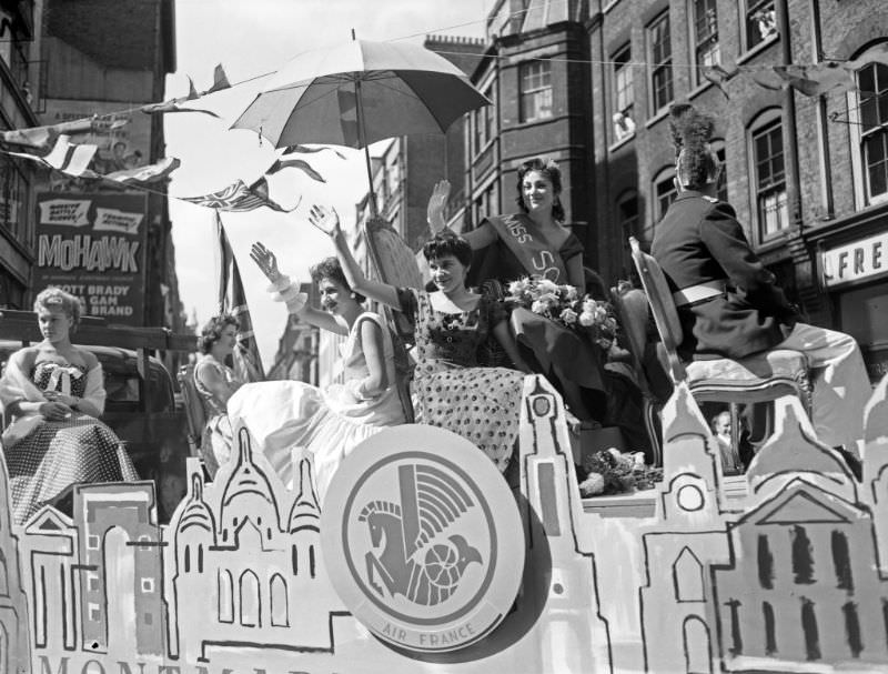 Miss Soho waving to the crowds during the annual Soho Fair, 1956.