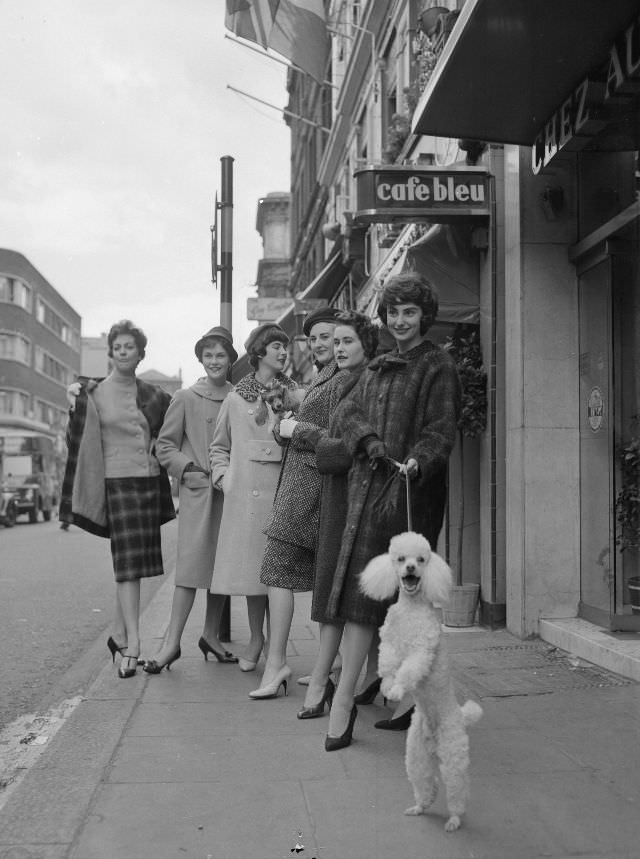 Six models giving a preview of the latest in French haute couture, 1958.