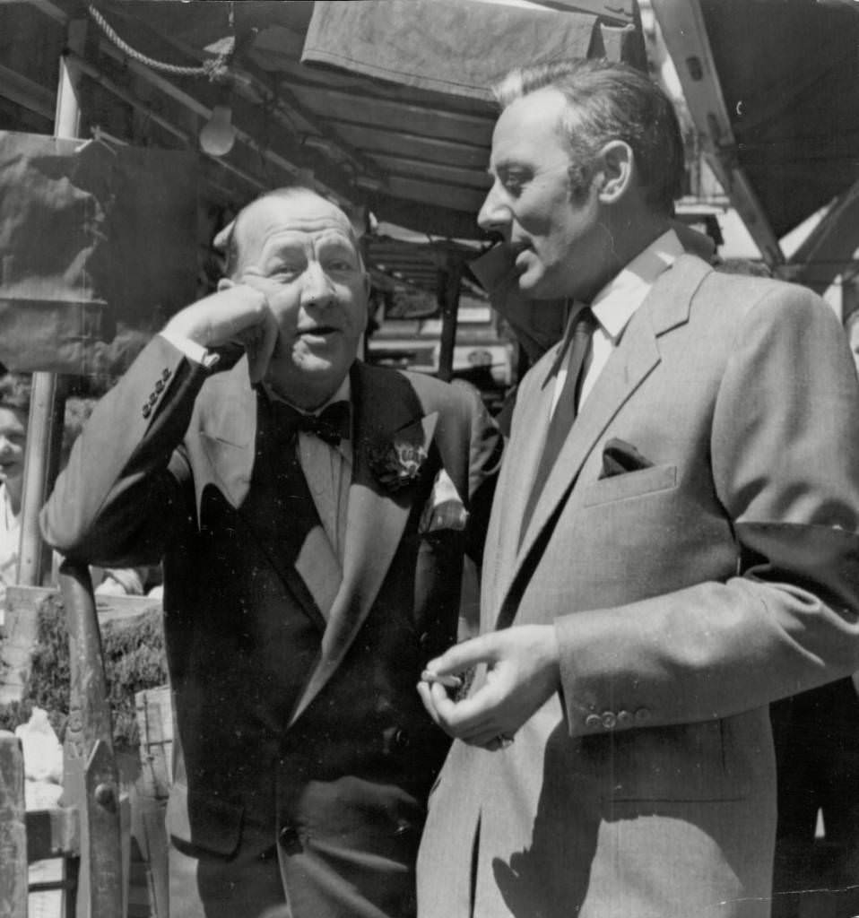 Noel Coward chats With Michael Wilding In Soho’s Berwick Market