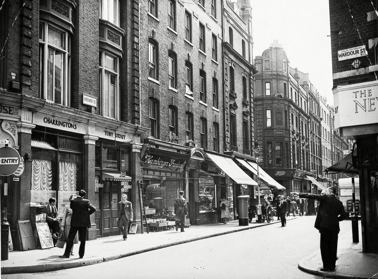 Brewer Street and the corner of Wardour Street in Soho, London, 29 Jul 1956.