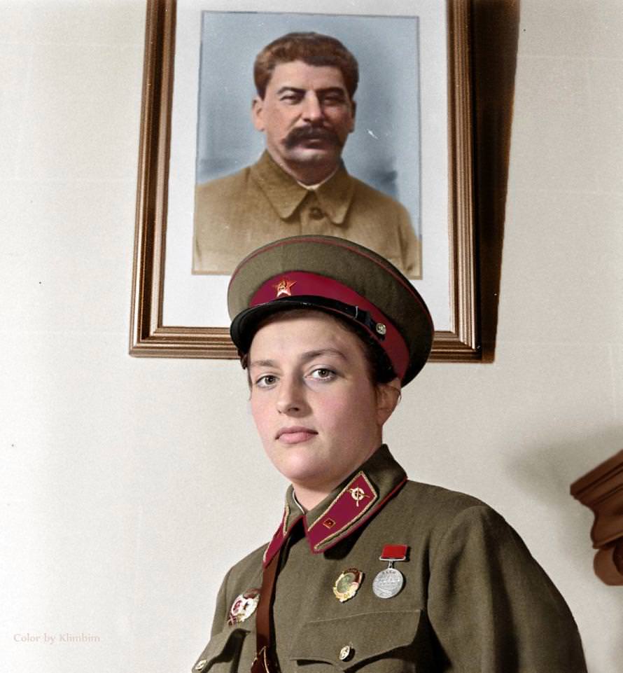 'Lady Death' is pictured wearing full uniform beneath a framed picture of Soviet dictator, Joseph Stalin.