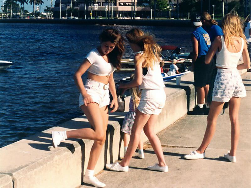 Three young women taking a break at the festival at the West Palm Beach waterfront on a warm day, 1992