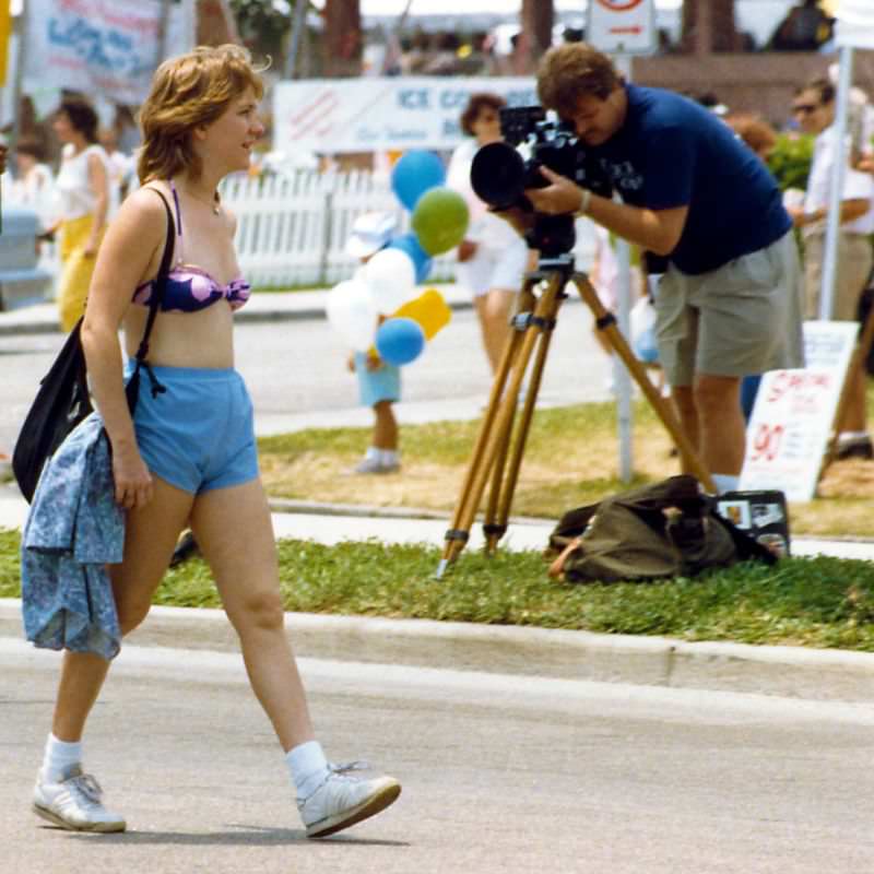 Lady passes pameraman, SunFest, 1988