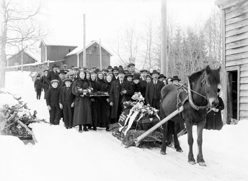 Funeral procession photographed at Teigen, Førde municipality. The deceased is a woman.