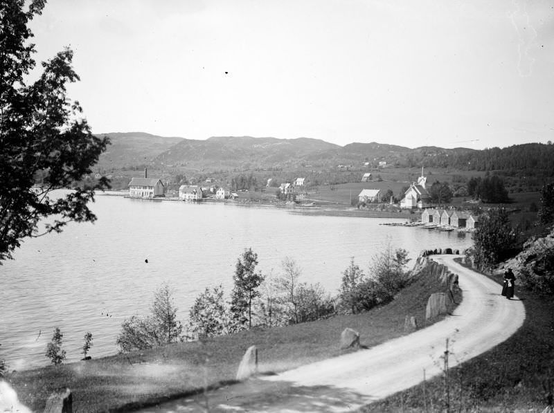 Holmedal in Askvoll municipality. On the right are several boat houses and Holmedal church.