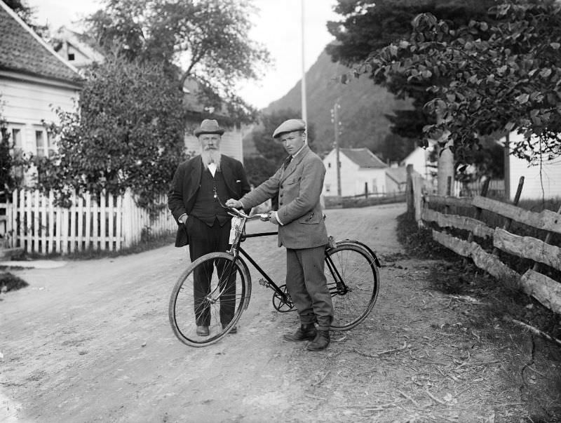 Three men photographed in the street outside photographer Olai Fauske's home and studio in Førde