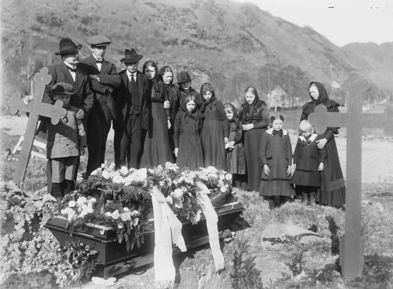 A family gathered around a coffin at the church yard