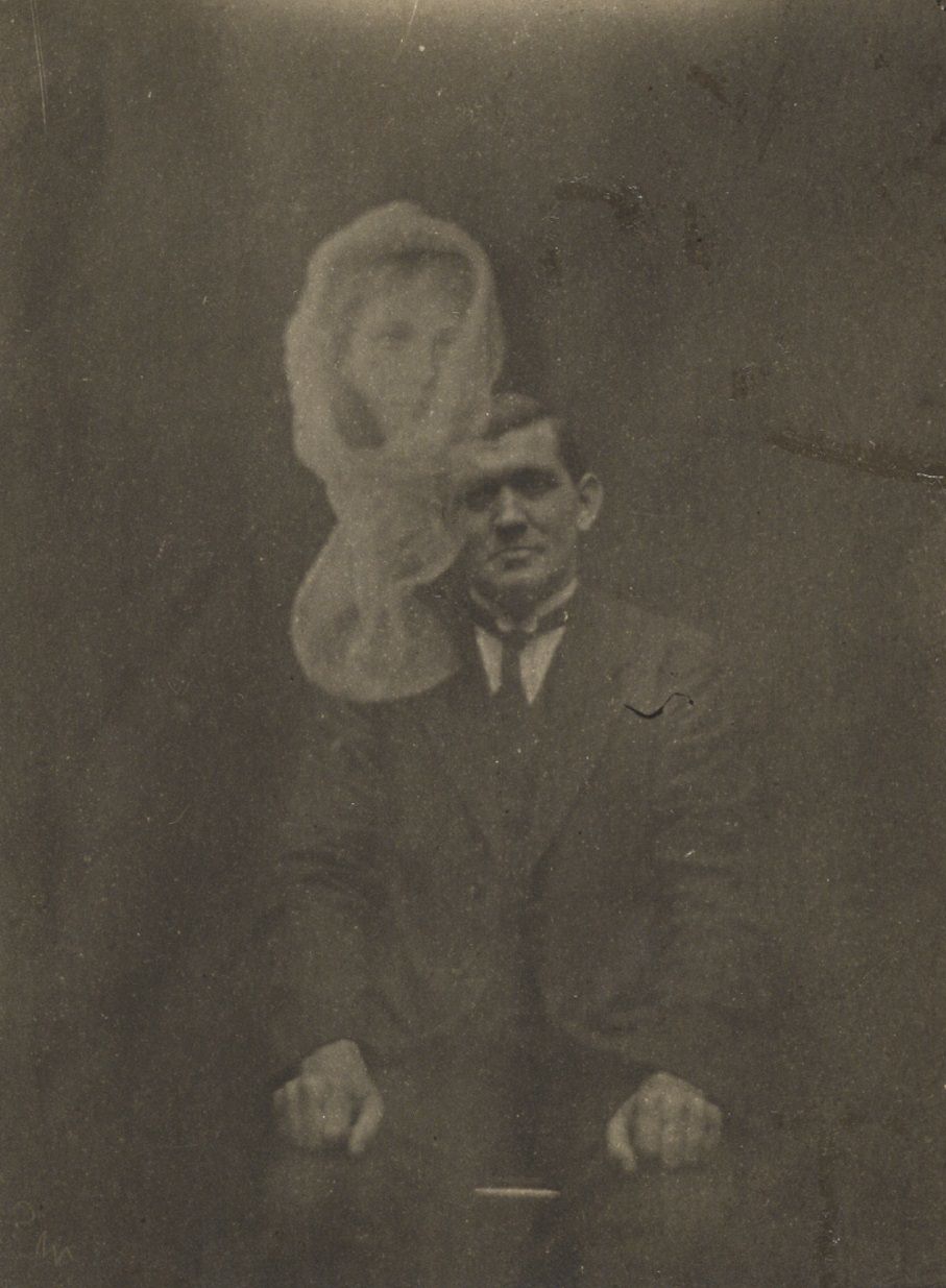 A shrouded woman's face appears above Welsh medium Joe Thomas.