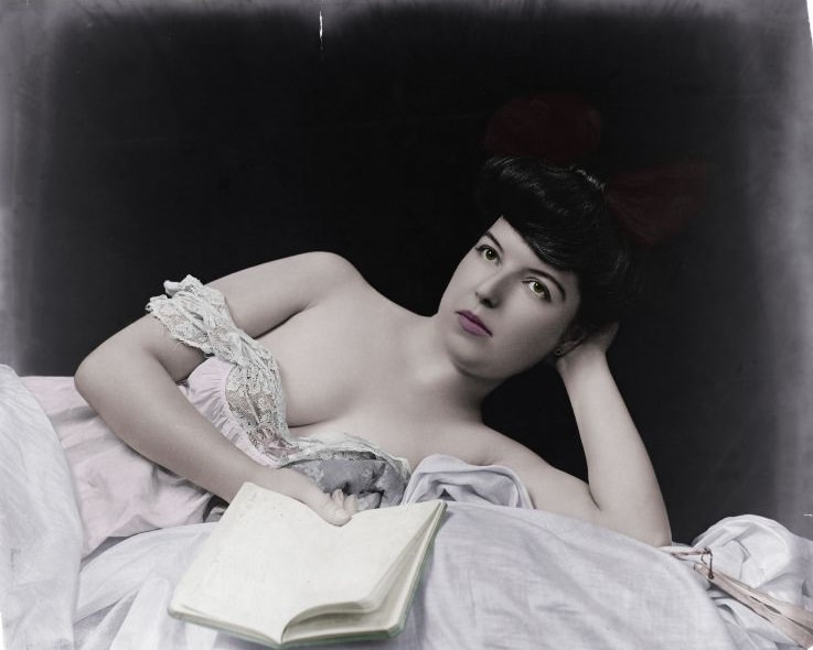 Young woman, wearing negligee lying on the bed