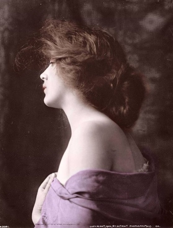 Woman model in profile with hand at bosom