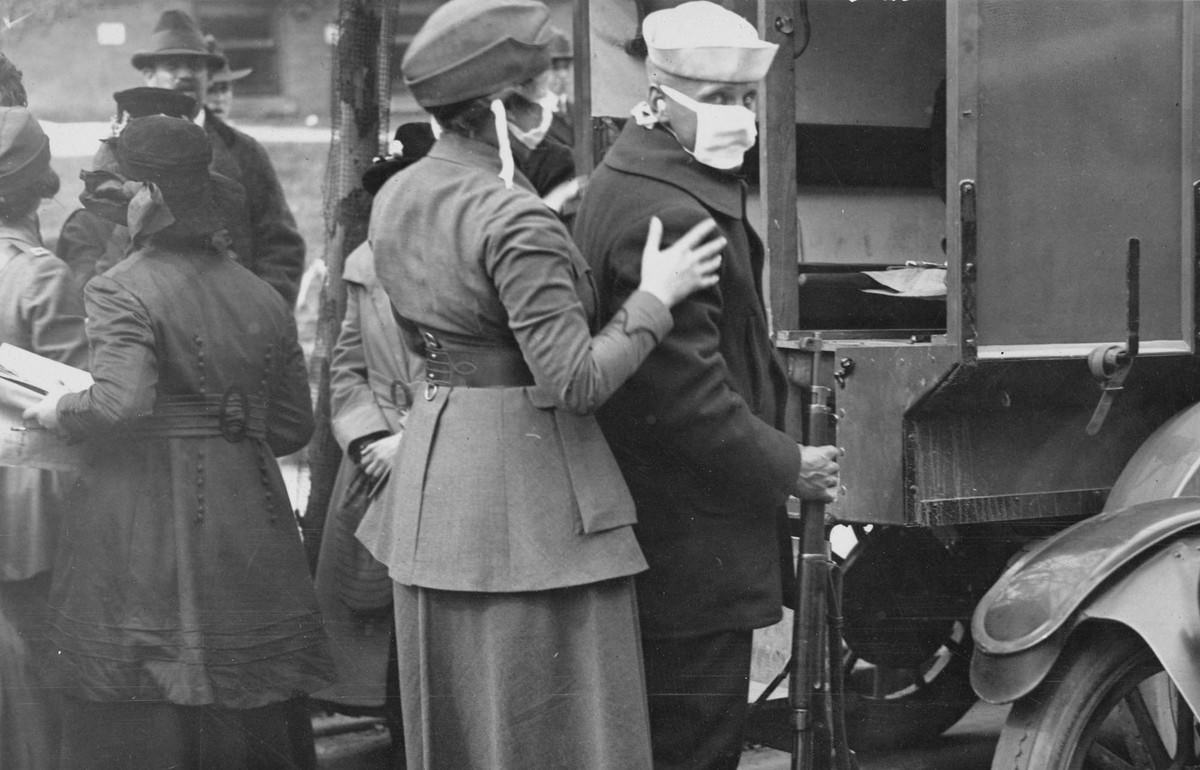 A sailor and a member of the Women’s Motor Corps wear masks while treating influenza patients injured by the explosions of a coal loading plant at Morgan, New Jersey, on October 5, 1918