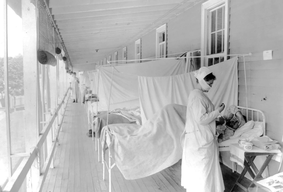 A nurse takes the pulse of a patient in the influenza ward of the Walter Reed hospital in Washington.