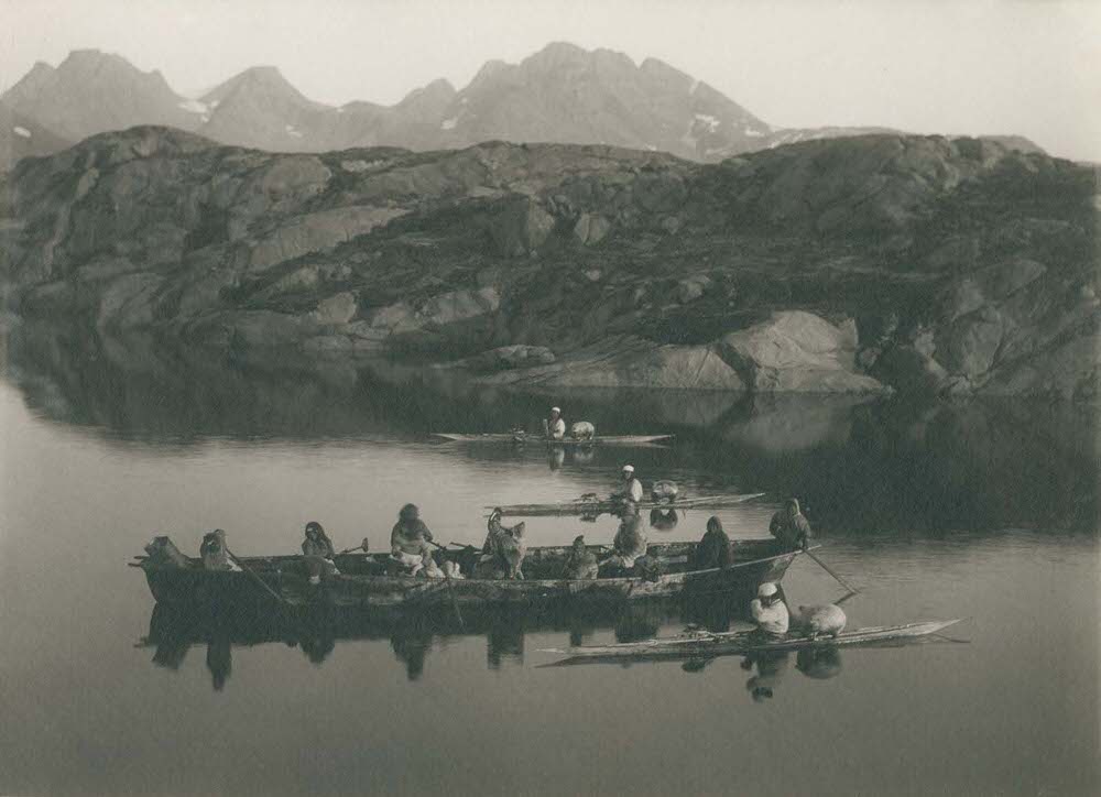 A boat and kayakers near Ammassalik, 1890s